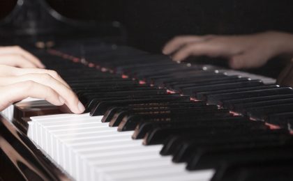 Close-up of hands playing the piano