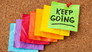 photo of crumpled colored note paper that says "keep going"