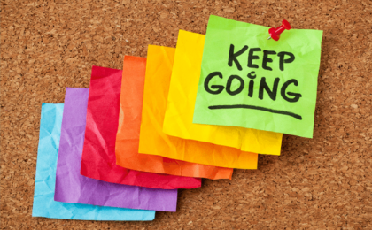 photo of crumpled colored note paper that says "keep going"