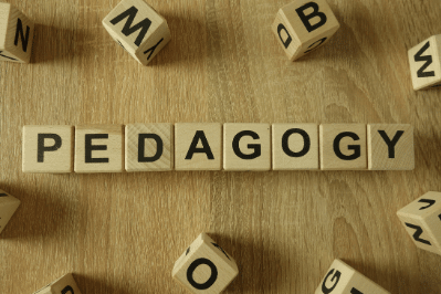 photo of letter blocks spelling out the word pedagogy
