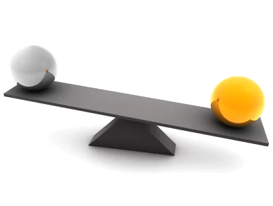 a silver ball and a gold ball on an unbalanced platform