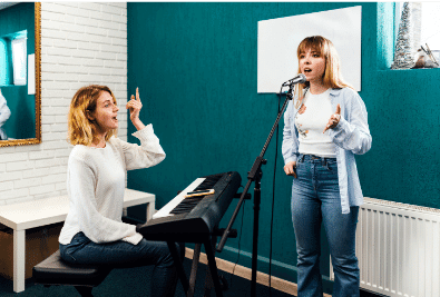 photo of two women in a vocal lesson