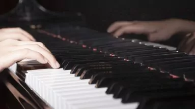 Close-up of hands playing the piano