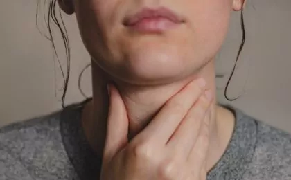 Woman with hand on her throat