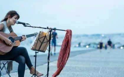 Woman playing guitar and singing