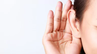 photo of a hand cupping an ear