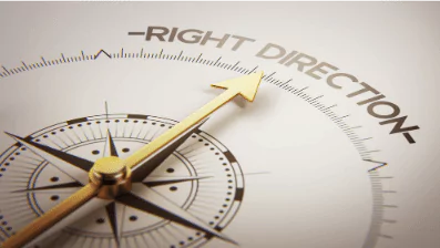 photo of a compass pointing to the words "right direction"