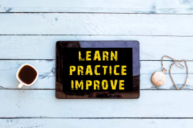 learn practice improve photo of a board that says "learn, practice, improve"