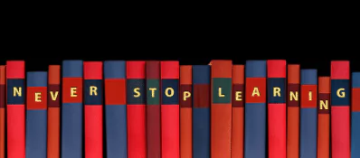 photo of a line of books saying "never stop learning"