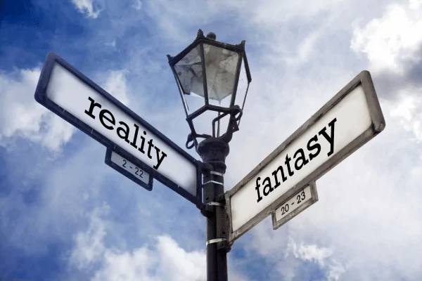 reality vs fantasy photo of a street post with "reality" and "fantasy" as the street signs
