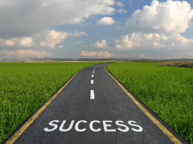 photo of a paved road with the word "success"