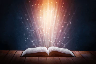stylized photo of an open book with colorful lights beaming from the pages