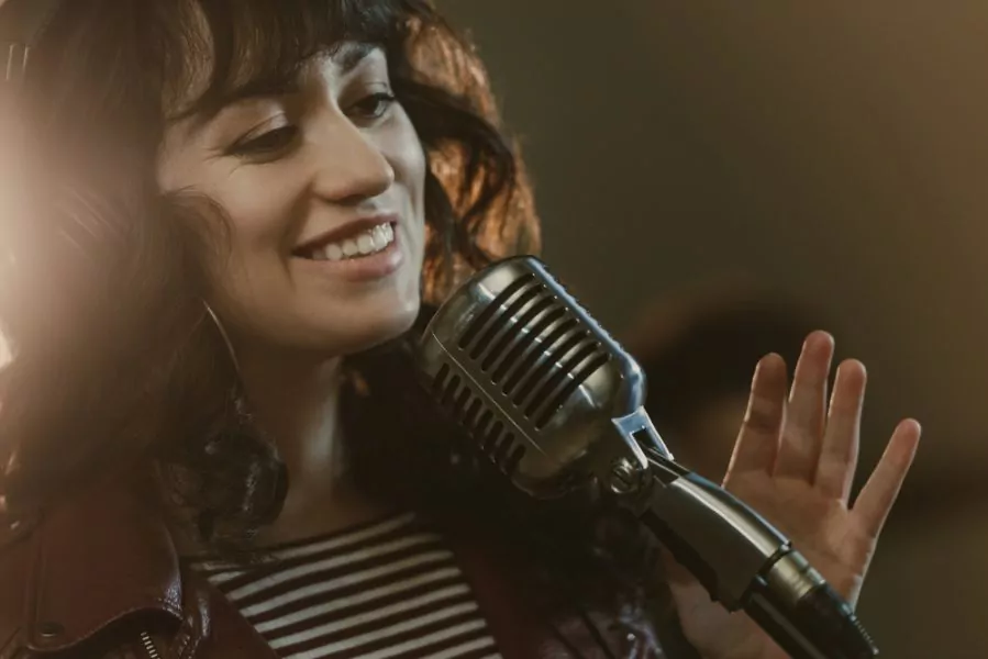 a singer smiling while singing