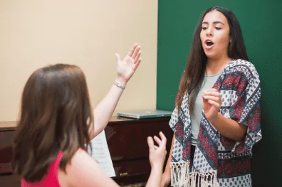 photo of a voice lesson between two women